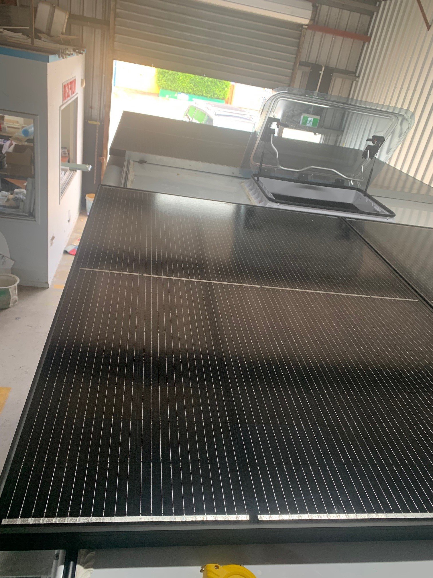 Caravan roof solar panel installation in workshop